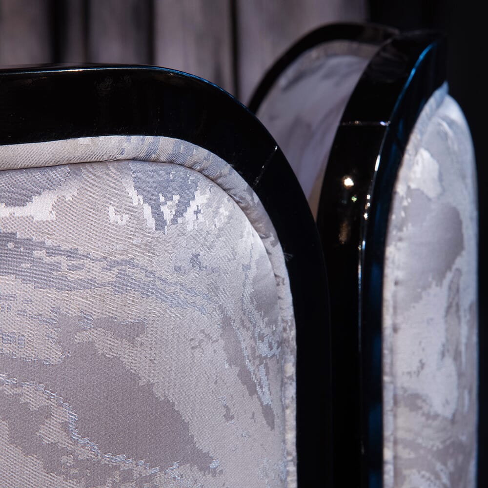 black lacquer detail and jacquard fabric on back of luxury dining chair