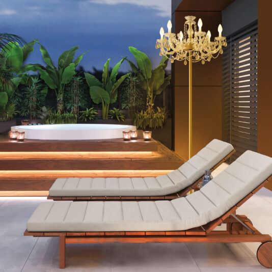 Outdoor Chandelier Floor Lamp Two cushioned lounge chairs face a jacuzzi amidst lush tropical plants on a patio. An Outdoor Chandelier Floor Lamp beside the chairs adds warmth, while wooden steps lead to the jacuzzi, and candles provide a soft glow.