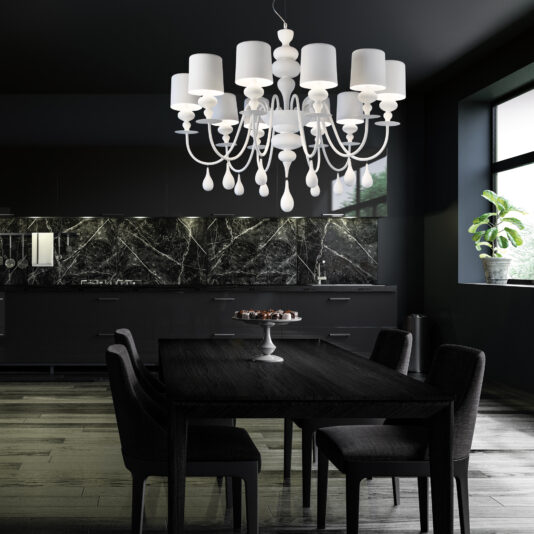 Contemporary High End White Chandelier A dining room features a dark wooden table with four chairs under a Contemporary High End White Italian Designer Chandelier. Black marble kitchen cabinetry contrasts with a large window, where a potted plant sits on the sill.