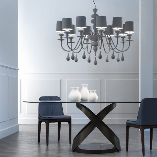 Contemporary High End White Chandelier The dining room features a glass-top table with an X-shaped base, two blue chairs, and three white vases. Overhead, the Contemporary High End White Italian Designer Chandelier with multiple lamps illuminates the soft gray walls and wooden floor.