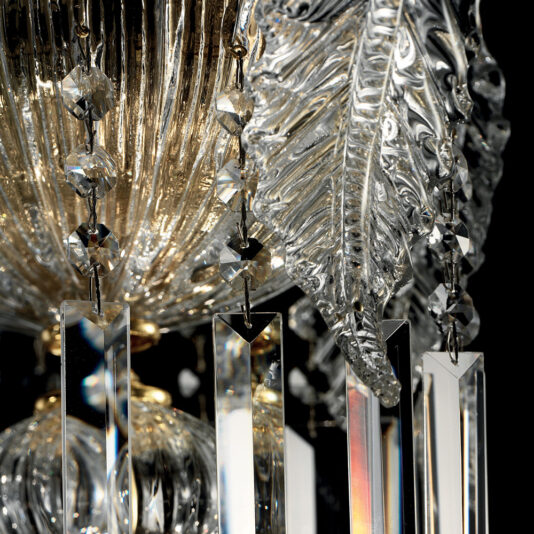 Close-up of the Ornate Italian Drop Crystal Pendant Chandelier, showcasing intricate glasswork, including leaf-shaped embellishments and multifaceted hanging prisms. The detailed craftsmanship and light reflections create a sparkling, luxurious effect against a dark background.