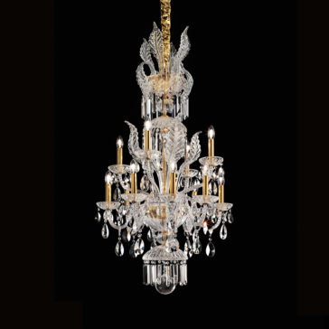 A luxurious crystal chandelier with intricate designs hangs against a black background. The Ornate Italian Drop Crystal Pendant Chandelier boasts multiple candle-like lights and elaborate crystal decorations, including clear crystal pendants and detailed floral motifs, all elegantly accented with gold highlights.