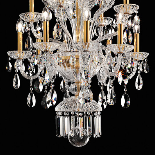 A close-up of the Ornate Italian Drop Crystal Pendant Chandelier showcasing its gold accents. The chandelier is adorned with intricate designs, teardrop-shaped crystals, and lit candle-style bulbs, creating a dazzling and elegant display against a black background.