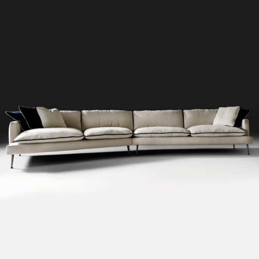 The Large Modern Modular Sofa showcases an elegant beige hue and plush cushions, complemented by dark accent pillows. Set against a contrasting dark background, the sleek metal legs and minimalist design make this sectional both comfortable and stylish.