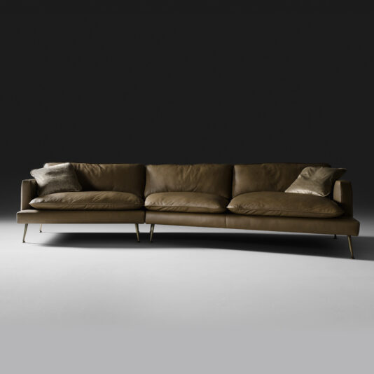 The Modern Leather Modular Sofa, finished in brown leather upholstery, comes with four plush cushions—two large seat cushions and two smaller throw pillows—perfectly set against a dark background. The sofa is designed with sleek, slim metal legs for a contemporary look.