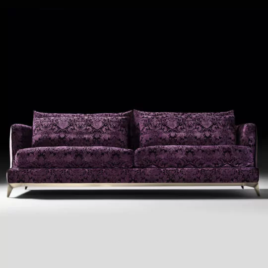 The Velvet Luxury Modern Sofa, upholstered in deep purple velvet with intricate damask patterns and equipped with two large back cushions, showcases sleek modern design and silver metal legs against a black background.