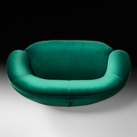 Contemporary Designer 2 Seater Sofa Here is a revised version of the sentence using the given product data:
The Contemporary Designer 2 Seater Sofa features a green, oval-shaped design with a plush, velvety texture. It boasts smooth, rounded edges and a deep seat, offering a cozy and inviting appearance. The sofa is showcased against a gradient background that transitions from black at the top to white at the bottom.