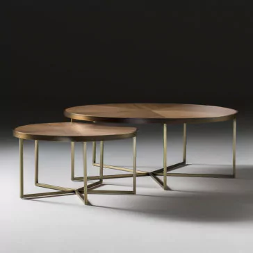 A pair of nested Contemporary Walnut Designer Coffee Tables, featuring round walnut tops and sleek angular gold metal frames, are set against a dark backdrop. The larger table is placed behind the smaller one with a slight overlap, accentuating their geometric design and modern aesthetic.