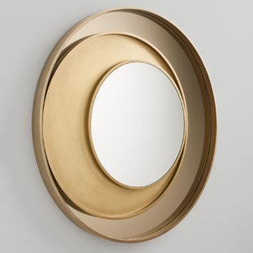 Modern Italian Designer Offset Circles Mirror The Modern Italian Designer Offset Circles Mirror showcases a contemporary Italian design with three concentric, overlapping golden frames at varying depths. These offset circles create an artistic and layered visual effect, centering the mirror within the innermost frame. It is mounted on a plain light-colored wall.