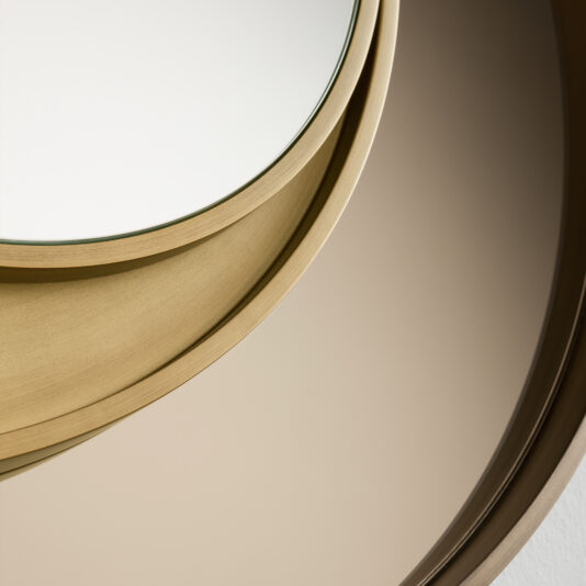 Close-up of a Modern Italian Designer Offset Circles Mirror, showcasing an overlapping circular design with gold-toned frames. The offset circles create an abstract pattern with varying reflections, highlighting the elegant and minimalist aesthetic.