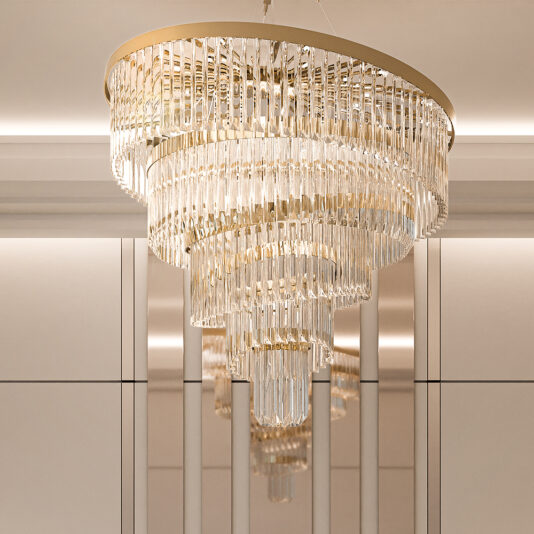The Gold Plated Spiral Crystal Designer Chandelier, with multiple tiers of sparkling glass prisms and a circular metallic rim, creates an elegant and opulent ambiance against a softly lit, minimalist background.