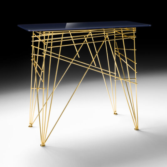 The Contemporary Designer Lacquered Console Table boasts a slim, rectangular blue top and an intricate geometric gold frame made of interwoven metal rods. Its elegant and artistic design stands out as an eye-catching and sophisticated piece of furniture against a gradient gray background.