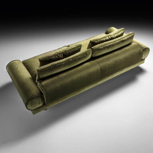 Contemporary Retro Inspired Designer Sofa Top view of the Contemporary Retro Inspired Designer Sofa in olive green, staged in a studio setting. This stylish piece boasts two backrest cushions and cylindrical armrests, set against a gradient background transitioning from gray to white. Soft lighting casts a gentle shadow beneath the sofa.