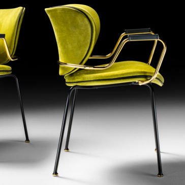 The High End Designer Retro Style Carver Dining Chair boasts a lime green cushioned seat and backrest, curved gold metal armrests, and a sleek black metal frame and legs. Showcased on a gradient black-to-white background, an identical chair is partially visible nearby.