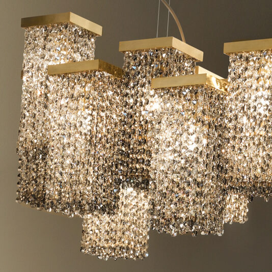 Large Italian Smoky Crystal Brass Contemporary Chandelier A close-up of the Large Italian Smoky Crystal Brass Contemporary Chandelier features multiple rectangular tiers adorned with smoky crystal beads. It showcases brass-colored square frames at the top, and the crystals create a cascading effect, reflecting light and adding a luxurious Italian feel to the setting.