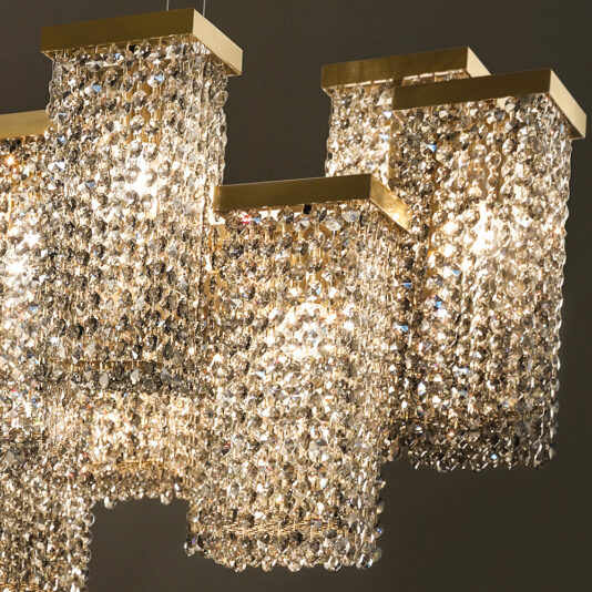 Large Italian Smoky Crystal Brass Contemporary Chandelier A Large Italian Smoky Crystal Brass Contemporary Chandelier with multiple rectangular tiers covered in smoky crystal beads and brass accents is hanging from the ceiling. The light from the bulbs above reflects brilliantly off the contemporary design, creating a dazzling and elegant display.