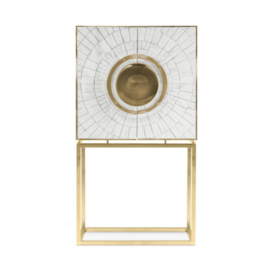 Exclusive Marble Art Deco Inspired Contemporary Cabinet The Exclusive Marble Art Deco Inspired Contemporary Cabinet showcases a modern, square design with a striking white tiled front adorned by a circular pattern and a central golden disc. This unique piece stands on a sleek, minimalistic gold metal frame, bringing an elegant and contemporary touch to any space.