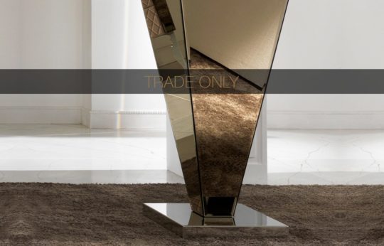 A mirrored, angular, and geometric structure is placed on a plush rug with a marble floor and neutral walls in the background. The text "TRADE ONLY" is overlaid across the middle of the image.