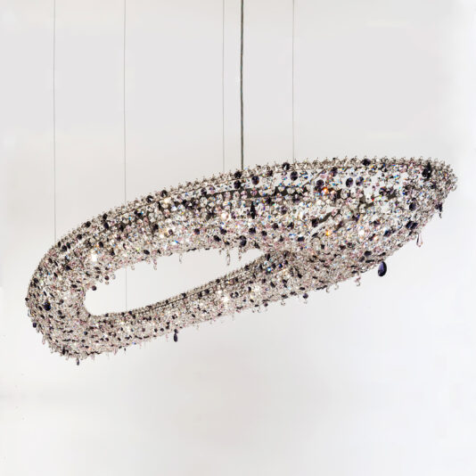 Contemporary Cut Crystal Chandelier The Contemporary Cut Crystal Chandelier, with its contemporary oval shape and intricate open design featuring numerous cut crystals, hangs elegantly from the ceiling. Suspended by several thin wires against a plain white background, it boasts a hollow center that adds a touch of sophistication to the room.