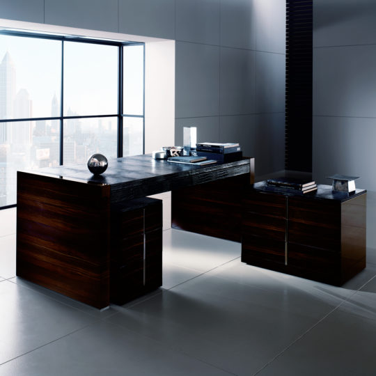 A bright, sleek office features the Contemporary Embossed Leather Ebony Desk with a dark wood finish, minimal decor, and city skyline views through large floor-to-ceiling windows.