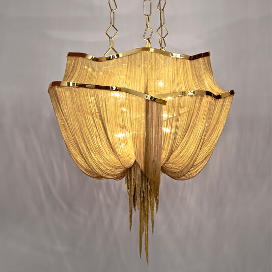 Luxury Gold Plated Chain Chandelier The Luxury Gold Plated Chain Chandelier boasts a flowing, draped design that attaches to the ceiling with an elegant chain. This exquisite chandelier features multiple layers of light cascading down like golden threads, creating a warm and opulent ambiance.