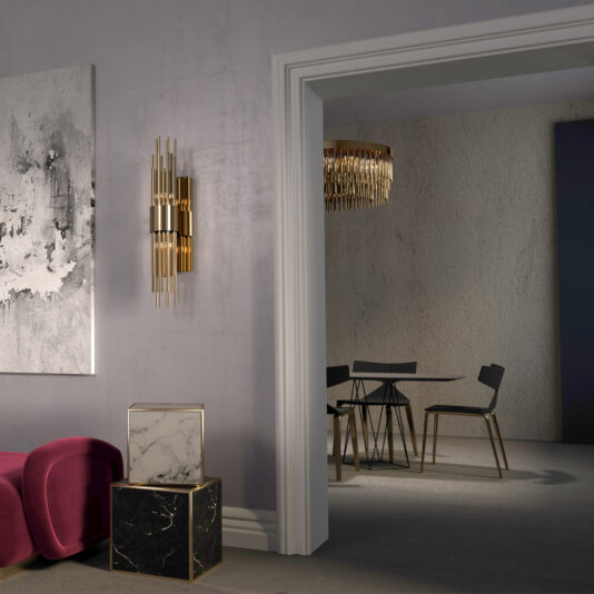 Gold Plated Designer Contemporary Chandelier A modern living space with a view into an adjacent room. The living room features an abstract painting, a gold wall sconce, a pink cushioned bench, and a marble-topped pedestal. The back room contains a minimalist dining table with black chairs and the Gold Plated Designer Contemporary Chandelier.