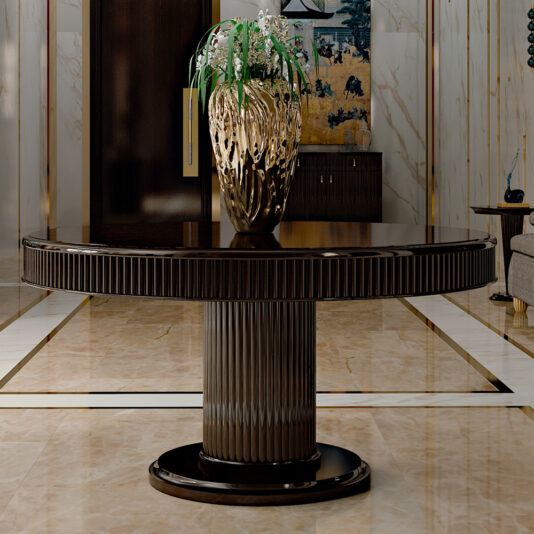 A sleek, dark wooden round table with a textured pedestal base stands on a glossy marble floor. Atop the table is an intricate gold vase holding white flowers, positioned against a backdrop of elegant wall art and furnishings in a luxurious room featuring an Italian Designer Lacquered Art Deco Inspired Dining Table.