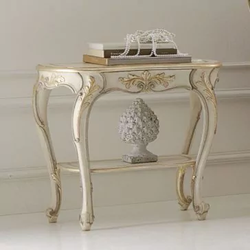 Opulent Carved Italian Bedside Table An Opulent Carved Italian Bedside Table with gold detailing, adorned with a stack of books and a string of pearls. Below, there is a decorative finial statue on the lower shelf. The table stands against a white wall with crown molding in a classic interior setting.