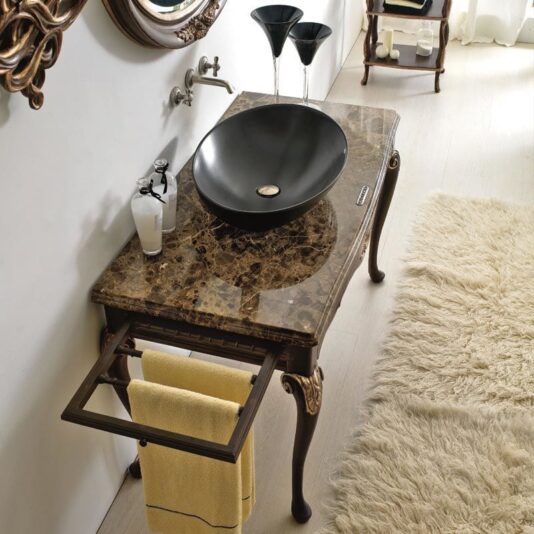 Marble Topped Designer Italian Bathroom Basin A Marble Topped Designer Italian Bathroom Basin paired with a luxurious marble countertop, featuring a wall-mounted faucet and an elegant towel rack adorned with a yellow towel. The floor is covered with a plush, soft white rug.