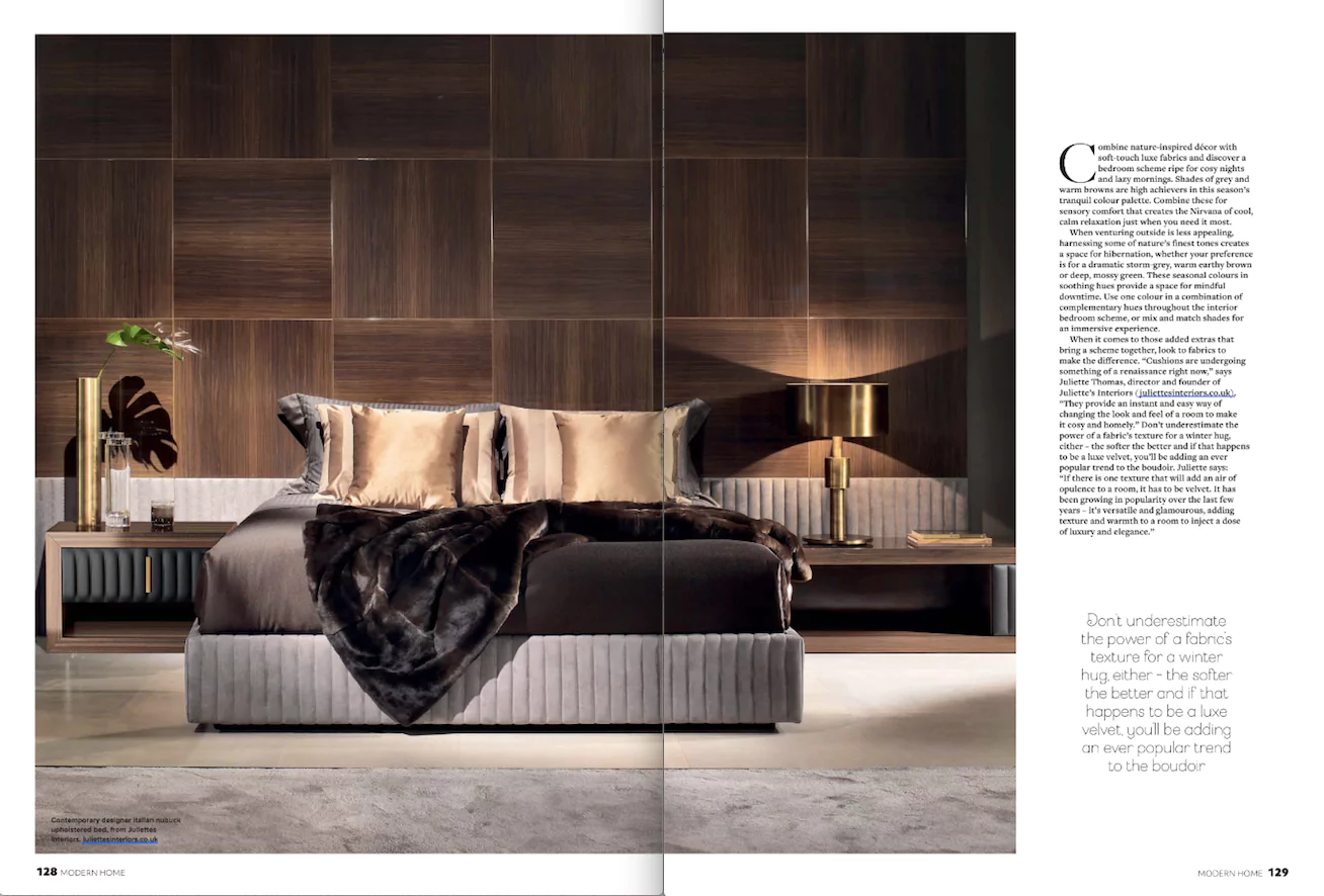 A modern bedroom exuding easy luxe vibes features a luxurious bed with plush brown and beige bedding, complemented by a dark wood-paneled accent wall and matching side tables with lamps. Text on the right delves into design elements reminiscent of sophisticated kitchens and bathrooms.