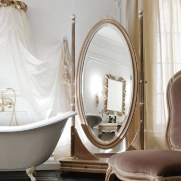 Ornate Wooden Italian Oval Dressing Mirror A luxurious bathroom with a freestanding bathtub and the Ornate Wooden Italian Oval Dressing Mirror. The room features elegant drapery, a plush chair with fabric upholstery, and intricate wall decor, all in a sophisticated, light color palette.