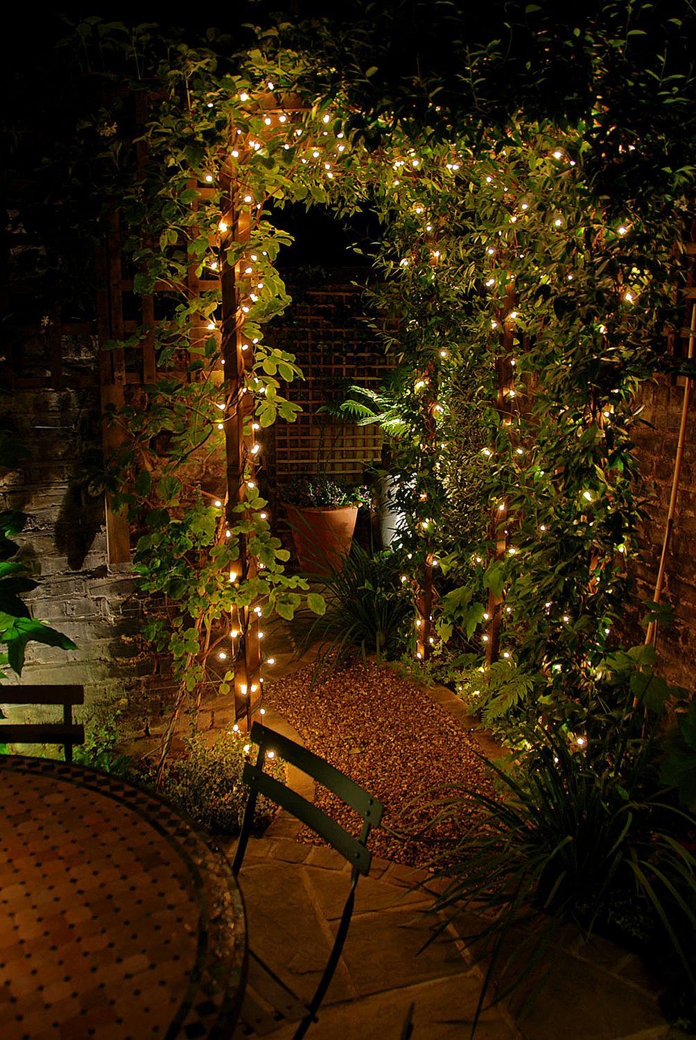 outdoor lighting, mini fairy light around a pergola with climbing plant
