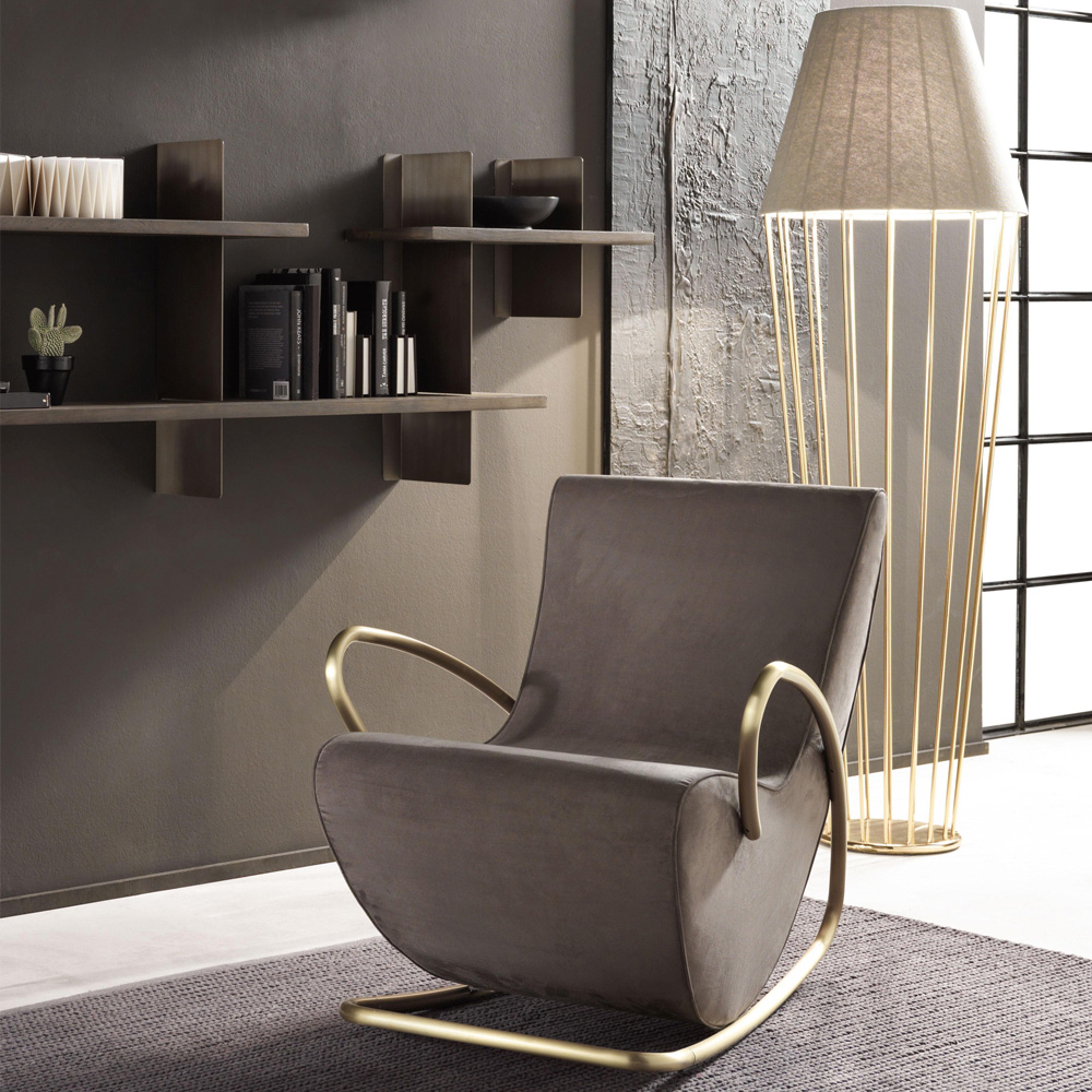 book nook, leather rocking chair with gold and linen floor lamp, wall mounted bookshelf