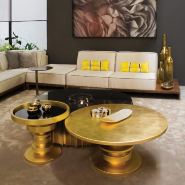 Striking Designer Round Coffee Table A modern living room features a beige corner sofa, yellow accent cushions, decorative gold vases, abstract art on a dark wall, and the Striking Designer Round Coffee Table, creating a stylish and contemporary space.