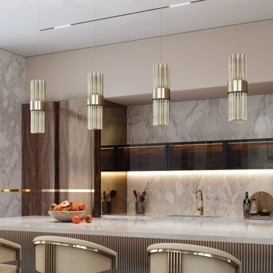 A modern kitchen features marble walls and countertops with wooden accents. Sleek Modern Vertical Pendant Lights in gold hang over a counter adorned with a fruit bowl. Soft lighting illuminates the space, creating a warm and inviting ambiance.
