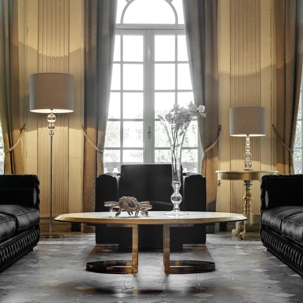 eclectic glamour interior design trend, classic room with high windows, tiled floor, and contemporary oval coffee table