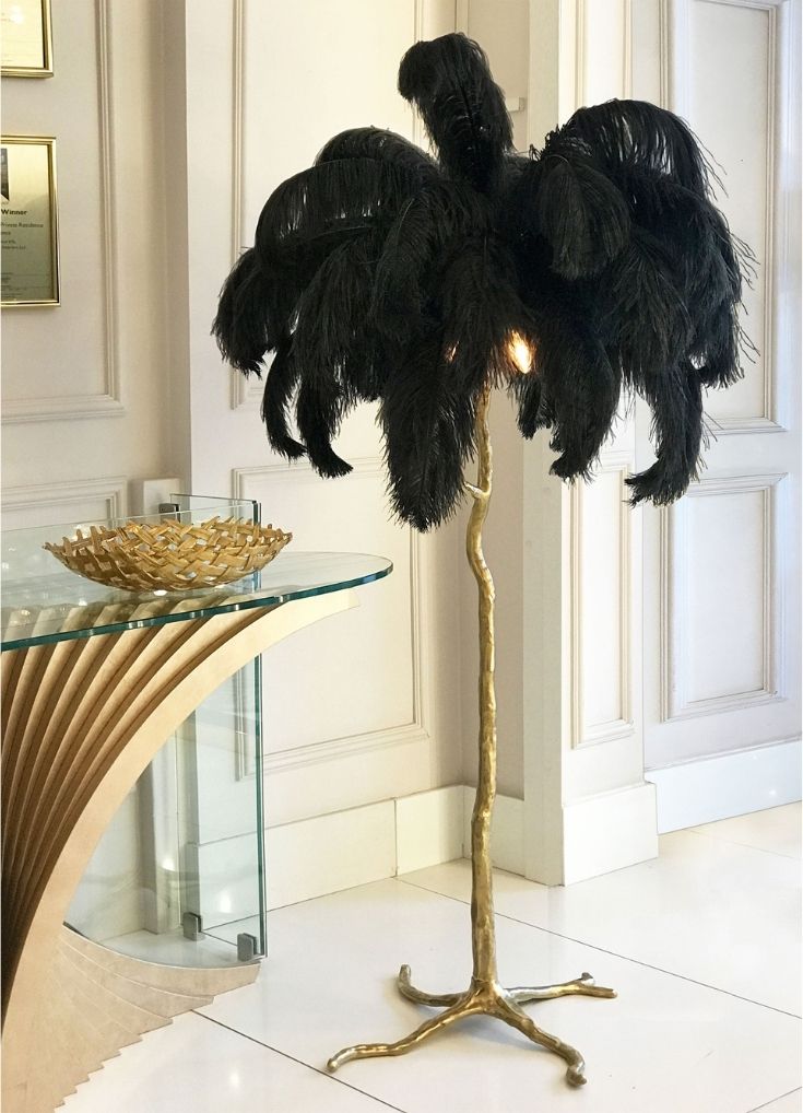 Luxury gift guide 2020. Fabulous, quirky floor lamp with gold, tree-like stem and flamboyant black feather top