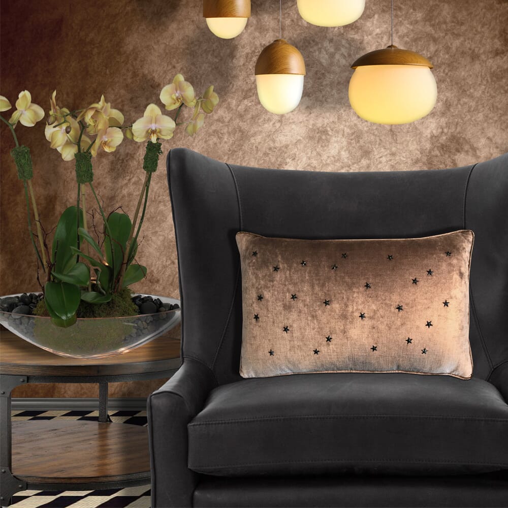 Deep warm grey armchair with a metallic bronze cushion