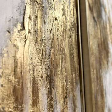 Original Gold Leaf Abstract Painting Close-up of the Original Gold Leaf Abstract Painting featuring a textured wall with gold and beige tones. The surface appears rough and uneven, with streaks and patches of gold paint, creating a luxurious, abstract look. The image captures the intricate details and depth of the texture.