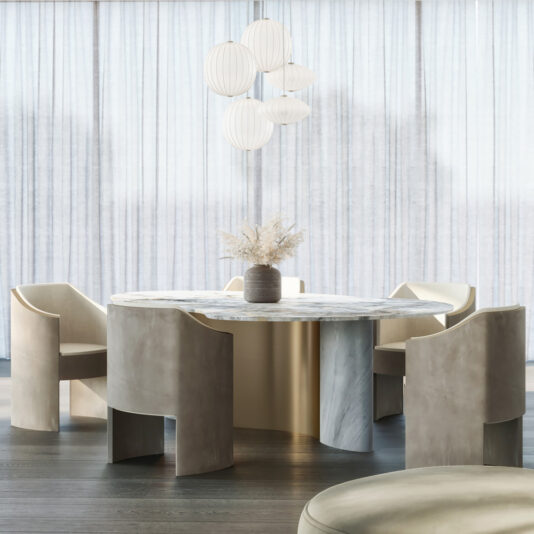 A modern dining room features the Exclusive Modern Precious Stone Dining Table, four beige upholstered chairs, a central vase with dried flowers, and white sculptural pendant lights above. Light curtains drape the large windows behind.