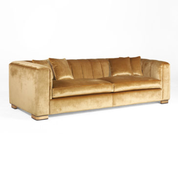 The High End Velvet 3 Seater Sofa boasts a luxurious, modern boxy design. Featuring a plush, tufted backrest and wide armrests, this sofa offers comfort with its two large seat cushions and three matching throw pillows, all set against a pristine white background.