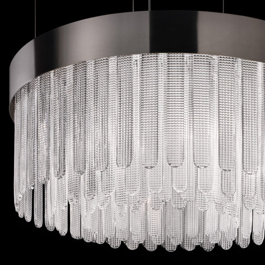 Contemporary Venetian Glass Chandelier Introducing the Contemporary Venetian Glass Chandelier: elegantly designed with a sleek, circular metal frame and adorned with numerous vertical, textured glass rods. This luxurious and intricate lighting fixture truly stands out against an entirely black backdrop, showcasing its exquisite details and form.