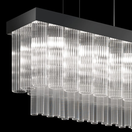 The Contemporary Glass Chandelier features a modern rectangular design with multiple vertical glass tubes hanging from its base, all suspended by three thin wires against a black background. The illuminated glass tubes create a bright and reflective display.
