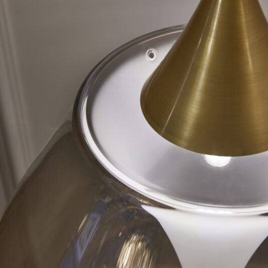 Exclusive Glass Pendant Light Cluster Close-up of the Exclusive Glass Pendant Light Set featuring a gold-colored cone-shaped fixture and a clear glass shade. The image highlights the top part of the lamp where the glass and metal converge, emphasizing its sleek and minimalistic design.