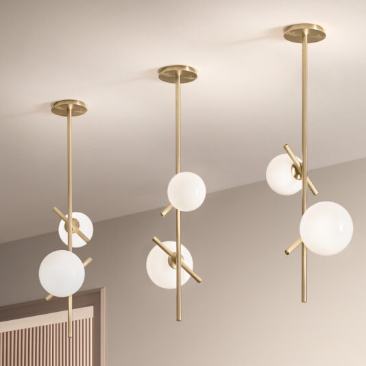 The Modern Murano Glass Vertical Pendant Light features three pendants suspended from the ceiling, each boasting brass rods and asymmetrically arranged spherical white Murano glass bulbs, creating a sleek and minimalist design.