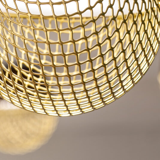 Modern Pendant Drop Cluster Chandelier Close-up of a metal wire mesh forming a spherical structure, reminiscent of the Modern Pendant Drop Cluster Chandelier, illuminated by a warm light source. The mesh consists of evenly spaced, square-shaped openings, and the background is softly out of focus.