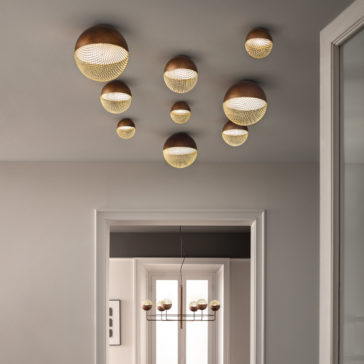 Modern Round Ceiling Light A modern hallway features a series of Modern Round Ceiling Lights in varying sizes with a woven pattern, casting a warm glow. A window at the end of the hallway allows natural light to filter through, perfectly complementing the contemporary decor.