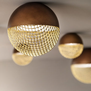 Modern Round Ceiling Light A close-up view of the Modern Round Ceiling Light showcases its elegant design, featuring brown half-spheres adorned with intricate golden mesh coverings. These lights emit a warm, ambient glow that beautifully illuminates the space. The background is softly blurred, revealing more identical ceiling lights in the distance.