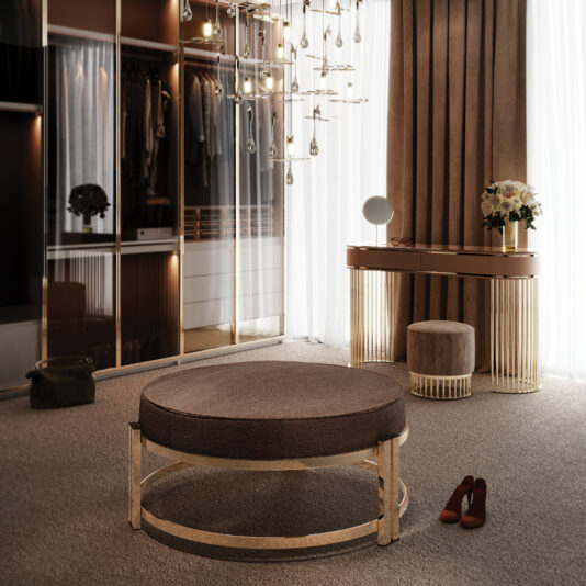 Luxurious dressing room featuring a round, upholstered ottoman with a gold base, a vanity table with a circular mirror, and a matching stool. A modern chandelier hangs from the ceiling, shoes placed on the carpeted floor, and a sleek wardrobe with glass doors stands beside the Modern Art Deco Style Console Table.