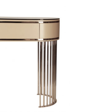 The Modern Art Deco Style Console Table is a sleek, contemporary piece featuring a semi-oval shape with a cream-colored, glossy finish and a glass top. It stands on vertically aligned, metallic gold legs that add an elegant touch. The background is white.